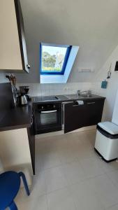 a kitchen with a sink and a window in it at Studio TRESTEL vue mer in Trévou-Tréguignec