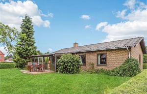 a brick house with a patio and a yard at 3 Bedroom Awesome Home In Hjrring in Hjørring