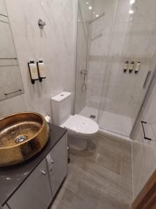 a bathroom with a sink and a shower with a toilet at FAMILY APARTAMENT II in Coimbra