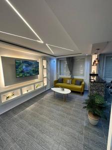 a living room with a yellow couch and a table at Kahina loft in Bejaïa