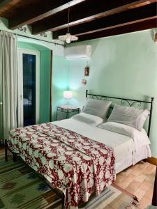 Schlafzimmer mit einem Bett mit einer roten und weißen Decke in der Unterkunft Affittacamere Le Terrazze in Corniglia