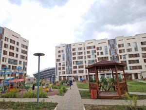 a park with a gazebo in front of some buildings at Expo Residence Astana in Astana