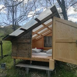 a large wooden house with a bed in it at BorgoGuerzano77 in Camugnano