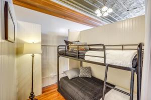 a bedroom with two bunk beds and a lamp at Cozy Abode in Historic Yankton - Heart of the City in Yankton