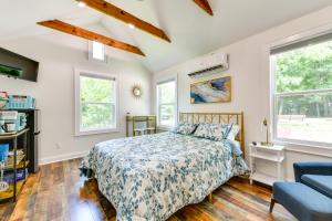 a bedroom with a bed and a couch and windows at Charming Winston-Salem Studio on Miller Park! in Winston-Salem