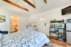 a white bedroom with a bed and a kitchen at Charming Winston-Salem Studio on Miller Park! in Winston-Salem