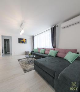 a living room with a couch and a table at Iggy Luxury Central Apartment in Hunedoara