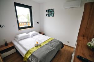 a bedroom with a large bed with a window at Noclegi u Szymonków Zator Przeciszów in Zator