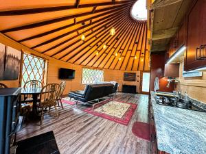 a living room with a couch and a dining room at Off-grid Yurt At Angel Valley Ranch in Duck Creek Village