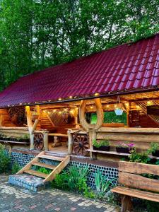 a large wooden house with a red roof at Girskiy Prutets in Bukovel +138 photos