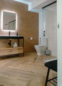 a bathroom with a sink and a mirror at La Banda Rooftop Hostel in Seville