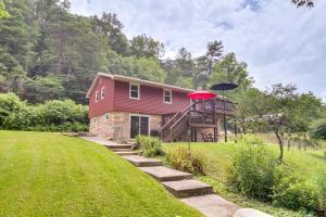 a small house with a red roof and a yard at Eagle Rock Cottage Cozy Creekside Getaway with Deck in Eagle Rock