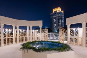 a white gazebo with a pool at night at The Ritz-Carlton, Doha in Doha