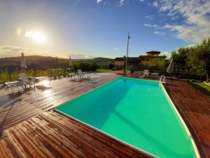 a swimming pool on top of a wooden deck at Agriturismo BioCore 2 - Colledoro in Giulianova