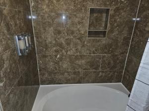 a bathroom with a shower with a bath tub at KING BED! Walk To AT&T Stadium, Globe Life in Arlington