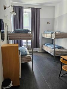 a room with three bunk beds and a window at Stora Ekeberg vandrarhem in Axvall