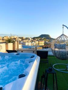 a hot tub on the roof of a house at Affittacamere La Magnolia in Bacoli