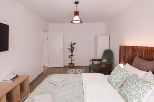 a living room with a bed and a table and a tv at Hannah's Apartment Ocna Mures in Ocna-Mureşului