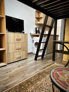 a living room with a tv and a washer and dryer at Ada's Luxury Apartament&Studio - Old City in Braşov