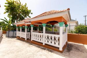 a gazebo with an orange and white at Runaway Bay Gem Suite in Runaway Bay