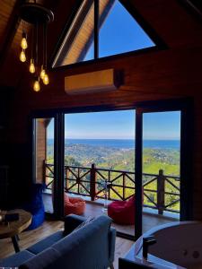 a living room with a view of the ocean at Moon House Bungalow in Rize
