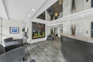 an office lobby with chairs and a bar at 1BD+Den condo, with free parking in Downtown! in Vancouver