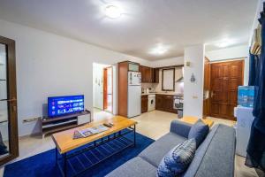 a living room with a couch and a table at Azure Apartment with Sea view in Kalkan in Kalkan