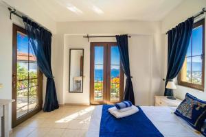a bedroom with a bed with a view of the ocean at Azure Apartment with Sea view in Kalkan in Kalkan