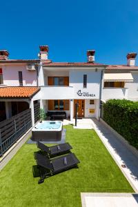 a backyard with a swimming pool and grass at Villa Andrea in Koper