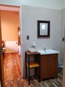 a bathroom with a sink and a mirror at HOTEL MIL ESTRELLAS-TOROTORo in Torotoro