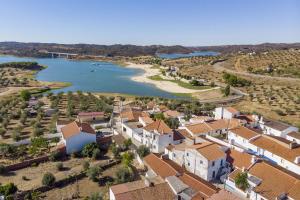 an aerial view of a village next to a river at Charming Amieira's Alqueva in Amieira