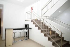 a staircase with a table and stools in a building at DMK Shared Apartments in Abuja