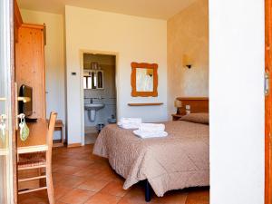 a bedroom with a bed with two towels on it at Hotel Ristorante La Baitina in Asiago