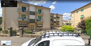 a white car parked in front of a building at Punto Zero in San Giovanni Valdarno