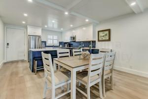 a kitchen and dining room with a table and chairs at High End Coastal Feel Condo in Fernandina Beach