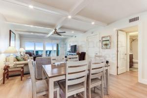 a dining room and living room with a table and chairs at High End Coastal Feel Condo in Fernandina Beach