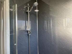 a shower in a bathroom with a glass door at Bottesford Apartments in Brumby