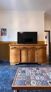 a living room with a large wooden entertainment center with a flat screen tv at Athenian Vintage Style 2 bdr apartment in Athens
