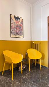 two yellow tables and chairs in a room at Athenian Vintage Style 2 bdr apartment in Athens