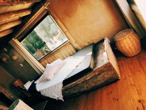 uma pequena cama num quarto com uma janela em Cabana Africana em Imaruí