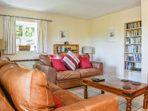 a living room with a couch and a coffee table at Holly Lodge in Bramerton