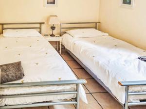 two beds sitting next to each other in a room at Holly Lodge in Bramerton