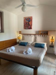 a bedroom with a large bed with towels on it at Casa vacanze a tre minuti a piedi dal mare IUN R1932 in Forte Village