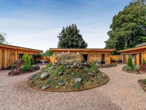 a garden with a rock in front of a building at Fioled - Uk40267 in Llangadfan