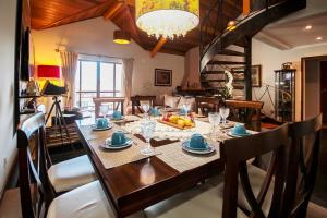 a dining room with a table with chairs and a dining room at Pousada Blumenau in Blumenau