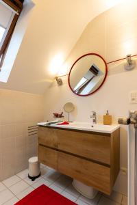 a bathroom with a sink and a mirror at L'Ermitage in Jalhay