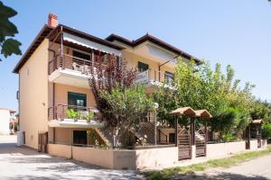 a building with balconies and trees in front of it at Elena Apartments in Asprovalta