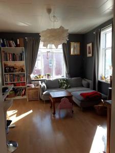 a living room with a couch and a table at Beautiful apartment in the heart of Reykjavik in Reykjavík
