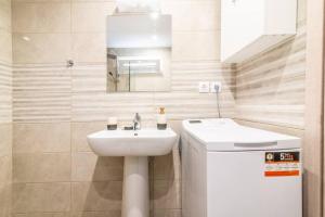 a white bathroom with a sink and a mirror at Modern & Stylish flat for friends & couples in Heraklio Town +22 photos