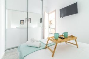 a living room with a table and a television at Modern & Stylish flat for friends & couples in Heraklio Town